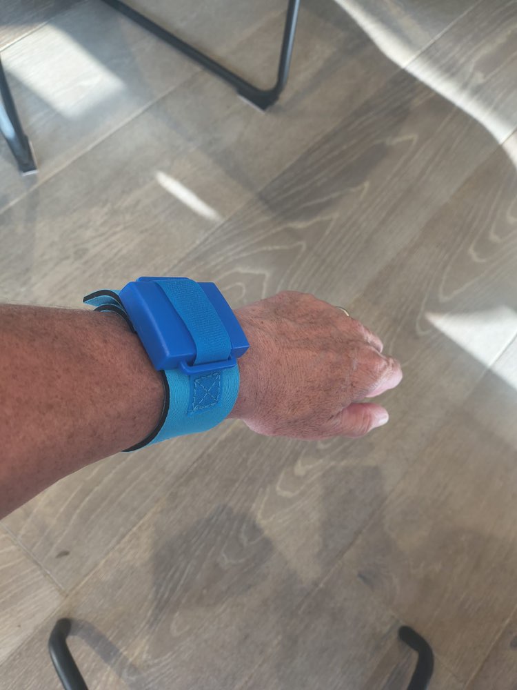 Timing chip on a blue strap worn around a wrist
