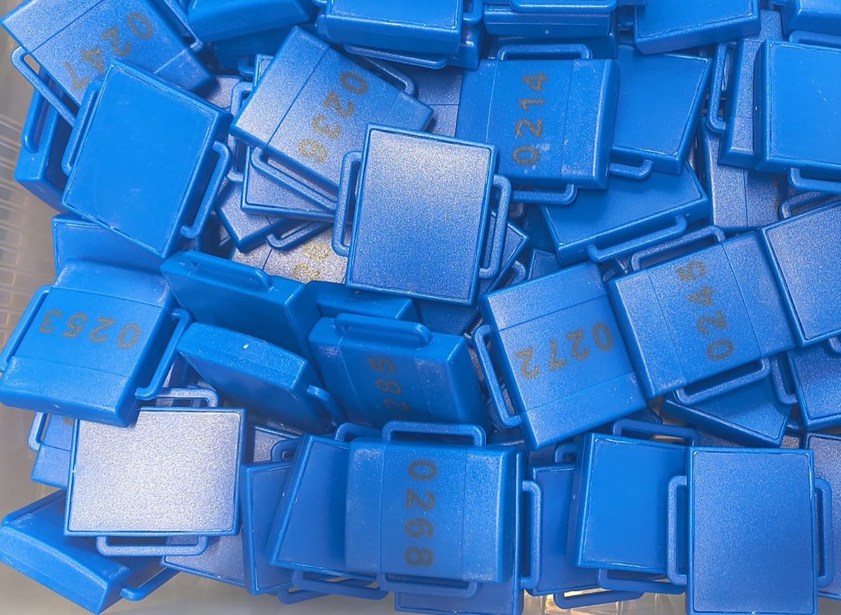 A box of blue Split Line timing chips, each printed with its own four-digit number such as 0214, 0245 and 0272